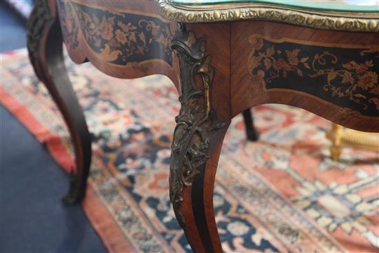 A 19th century Louis XV style marquetry, ebony and kingwood centre table, W.4ft 4in. D.2ft 9in. H.2ft 7in.